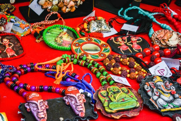 Handmade colourful Indian bead jewelleries being laid on a table for sale.